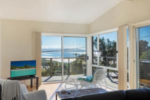 a living room with a view of the ocean at Surfside in Pambula Beach