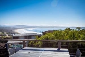 a view of the beach from the balcony of a house at The Love Shack in Pambula