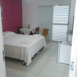 Säng eller sängar i ett rum på HOTEL CLUBE AZUL DO MAR