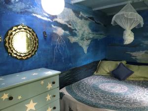 a childs bedroom with a mural of a world on the wall at Estância Verde in Valença