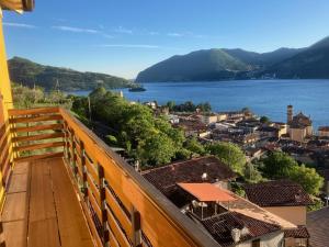 a balcony with a view of a town and a lake at CasaGialla in Marone