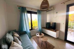 A television and/or entertainment centre at Seaview dreamy apartment with a pool and garden