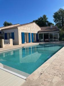 a swimming pool in front of a house at Villa 180 m2 piscine in Draguignan