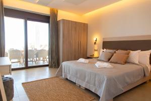 a bedroom with a large bed and a balcony at Villa Despina - Marathia View Private Luxury Villa in Marathias