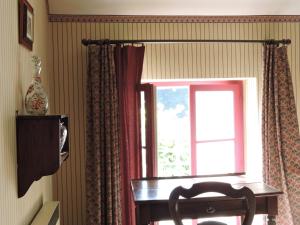 a window with a table and a chair in front of it at Le Domaine de Mestré, The Originals Relais in Fontevraud-l'Abbaye