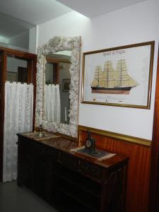 a bathroom with a wooden dresser and a mirror at Hostal Vila del Mar in Lloret de Mar