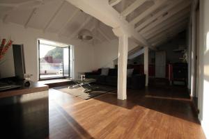 a living room with a couch and a tv at Pensión Iturriza in Donostia-San Sebastián