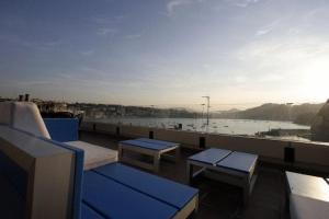 a balcony with benches and a view of the water at Pensión Iturriza in Donostia-San Sebastián