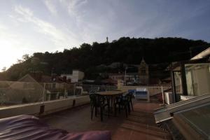 a balcony with a table and chairs on a roof at Pensión Iturriza in Donostia-San Sebastián
