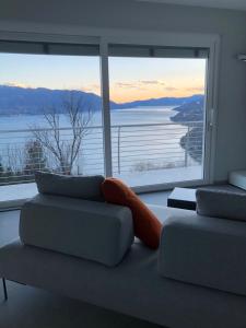 a living room with a couch and a large window at Ilfico in Cannero Riviera
