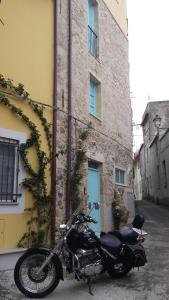 a motorcycle parked in front of a building at DOMO TIA ROSINA (I.U.N. P3203) in Cuglieri