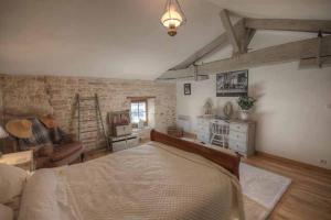 a bedroom with a large bed and a living room at 4Bed3Bath 1736 Farmhouse Barn Conversion-Hearth in Sainte-Soline