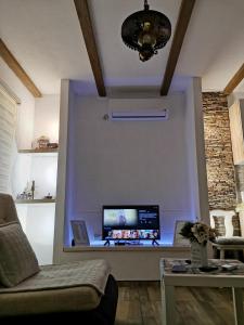 a living room with a computer on a wall at Nektar Park Villa Sara in Bihać
