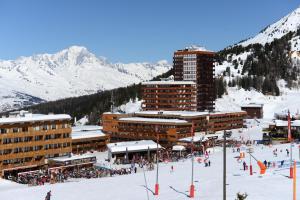 a group of buildings on a ski slope in the snow at Résidence Odalys Le Pelvoux in La Plagne