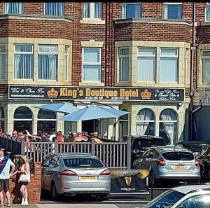 a group of cars parked in front of a restaurant at Kings Boutique Hotel in Blackpool