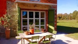 a table and chairs in front of a window at Colonica Il Picchio Verde in Altopascio