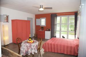 a room with a table and a bed and a table and a room with at Colonica Il Picchio Verde in Altopascio +16 photos