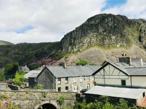 a village with a mountain in the background at Pisgah Guesthouse Snowdonia in Blaenau-Ffestiniog