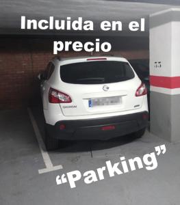 a white car parked in a parking lot at En Palencia capital céntrico con garaje Roberto in Palencia