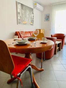 a dining room with a wooden table and chairs at Apartment Alexandra in Premantura