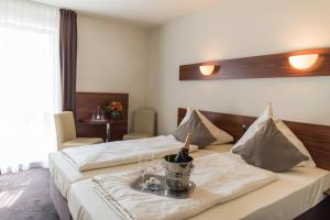Postel nebo postele na pokoji v ubytování Hotel am Wall