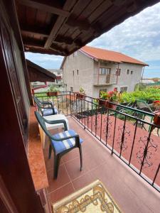 a balcony with two chairs and a railing at CASA LEXIMAR in 2 Mai