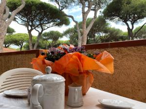 a table with a vase of flowers on top of it at Eden Appartamenti in Marina di Grosseto
