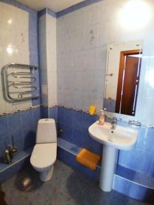 a bathroom with a white toilet and a sink at Stella Guest House in Anapa