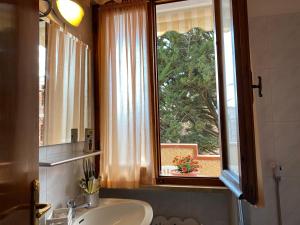 a bathroom with a sink and a window at Eden Appartamenti in Marina di Grosseto +196 photos