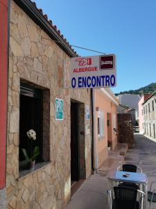 a sign on the side of a building at O Encontro in Fisterra
