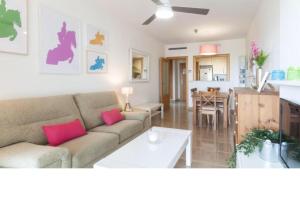 a living room and kitchen with a couch and a table at SALTO DE DUNE (Junto al MET y campo de GOLF) in Oliva +16 photos