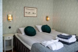 a hotel room with a bed with towels on it at Fregatten Bed & Breakfast in Karlskrona