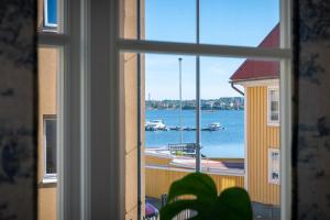 a window with a view of a harbor with boats in the water at Fregatten Bed & Breakfast in Karlskrona
