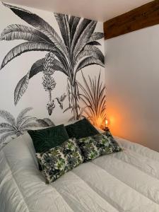a bedroom with a bed with a plant mural on the wall at Appartement Cosy Centre Historique Avignon in Avignon