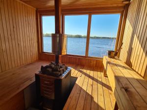 a inside of a cabin with a view of the water at Lämmijärve parvsaun in Värska