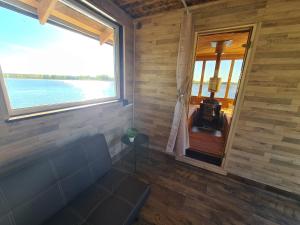 a room with a couch and a large window at Lämmijärve parvsaun in Värska