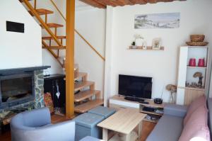 a living room with a couch and a fireplace at Chata Zofka in Ižipovce