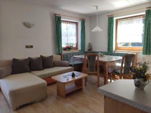 a living room with a couch and a table at Obkirchhof in Unsere Liebe Frau im Walde