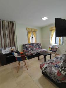 a living room with a couch and a table and chairs at Casa Carreira Bierzo in Ponferrada