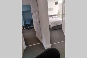 a bedroom with a bed and a room with a mirror at place by the sea in Bridlington