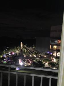 a view of a parking lot at night with a bridge at Calm & Cozy Hideaway in Tunkong Manga