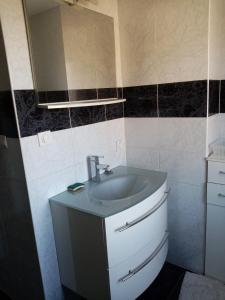 a bathroom with a sink and a mirror at Chez patou in Jezainville