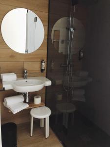 a bathroom with a sink and a mirror and a shower at Hotel Bed4U Bilbao in Bilbao
