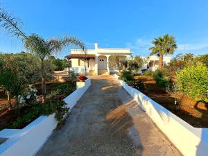 una casa con un sentiero di fronte a un cortile di Villa Mele a Lido Marini