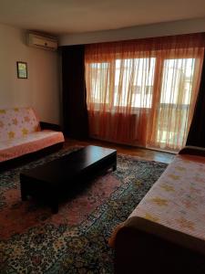 a living room with a couch and a coffee table at Iris&carina in Eforie Sud