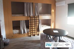 a room with two bunk beds and a table at D. Irene Hostel in Lajes