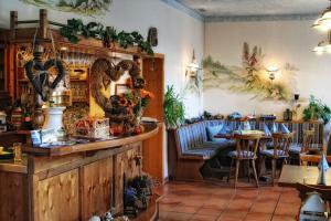 a restaurant with a table and chairs in a room at Gasthof Landhaus Adorf in Bad Elster