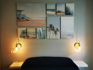 a bedroom with four pictures on the wall at Rihuete 2 in Puerto de Mazarrón