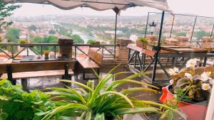 een balkon met tafels en planten en een parasol bij The best view on Tbilisi in Tbilisi City