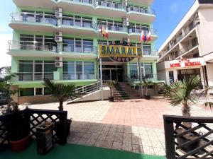 a large building with a sign in front of it at Hotel Smarald in Eforie Nord